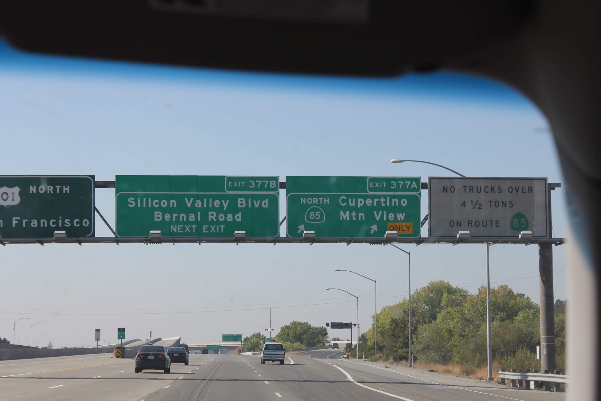 Highway road signs in Silicon Valley showing directions to Cupertino, Mountain View, and Silicon Valley Blvd, symbolizing the heart of the tech world.